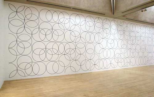 Bridget Riley. Installation at Tate Britain - Room 1, L-R: Composition with Circles 3, 2003. Graphite, acrylic paint and permanent marker on plaster wall, 483 x 1760 cm © 2003 Bridget Riley.