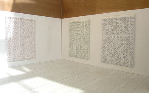 Reni Gower/Tamin Sahebzada. Installation view: (left to right) Papercuts: White/copper, Papercuts: White/emerald, Papercuts: White/cobalt, 81 x 56 in each, and Tamim Sahebzada, Wall tracing 60 x 10 in.