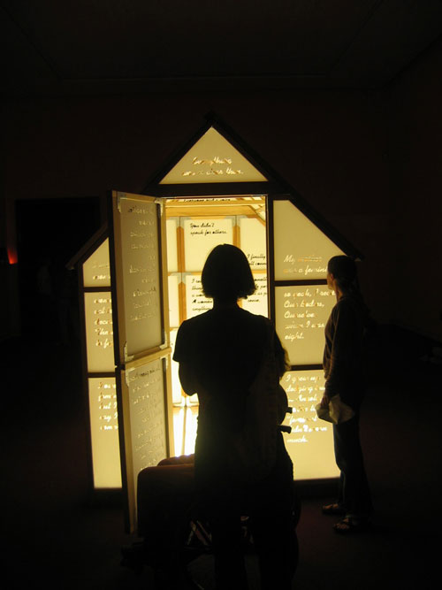 Mary Kelly and Ray Barrie. Love Songs, 2005–7. <em>Multi-Story House</em>, 2007. Wooden frame, cast acrylic panels, plate glass floor, fluorescent light, 244 x 183 x 244 cm. Courtesy Jose Carlos Teixeira and the artist. Collection of the artist.