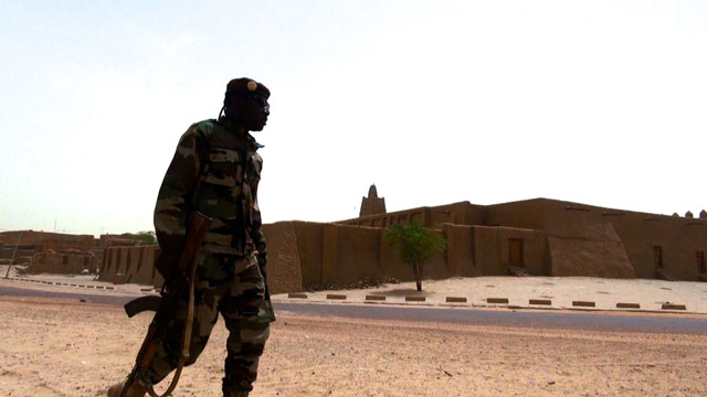 A Malian soldier patrols the reconstructed tombs of Timbuktu, destroyed by extremists in 2012.